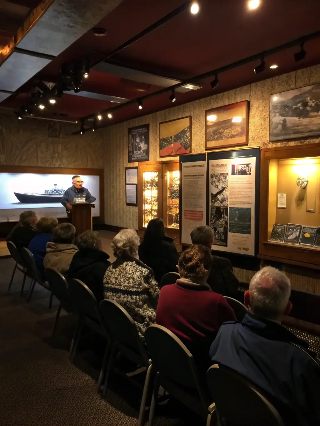 An image of a group of children and adults participating in an educational workshop about the history of Auriac-l'Église, held in a historic building.